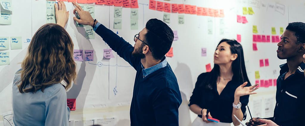 Participants at a workshop using sticky notes to plan a project.