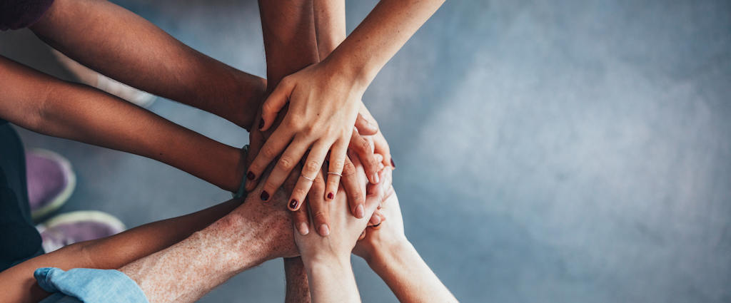 People with their hands on top of each other.