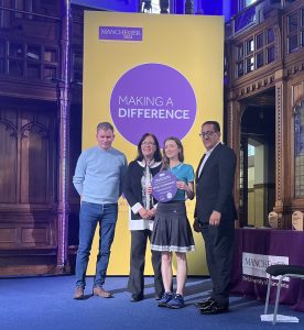 Dan Stears, Elizabeth Monaghan and Dr Leah Quinlivan on stage receiving the Making a Difference Award